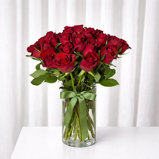 24 long stemmed red roses in a vase